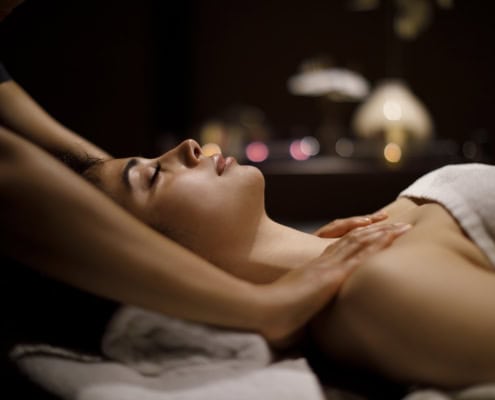Woman enjoying massage in spa center